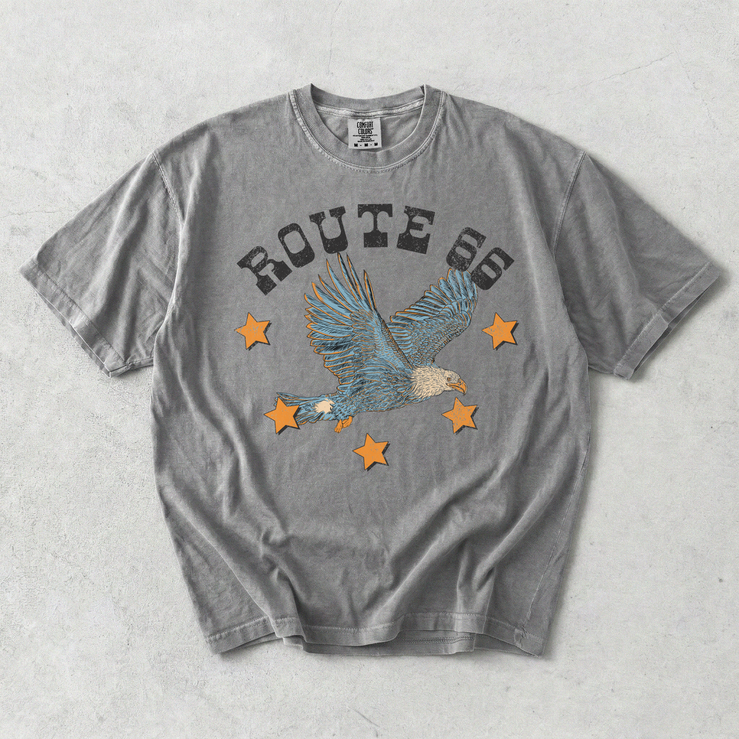 Grey Comfort Colors Route 66 eagle graphic tee flat lay with vintage distressed Americana design