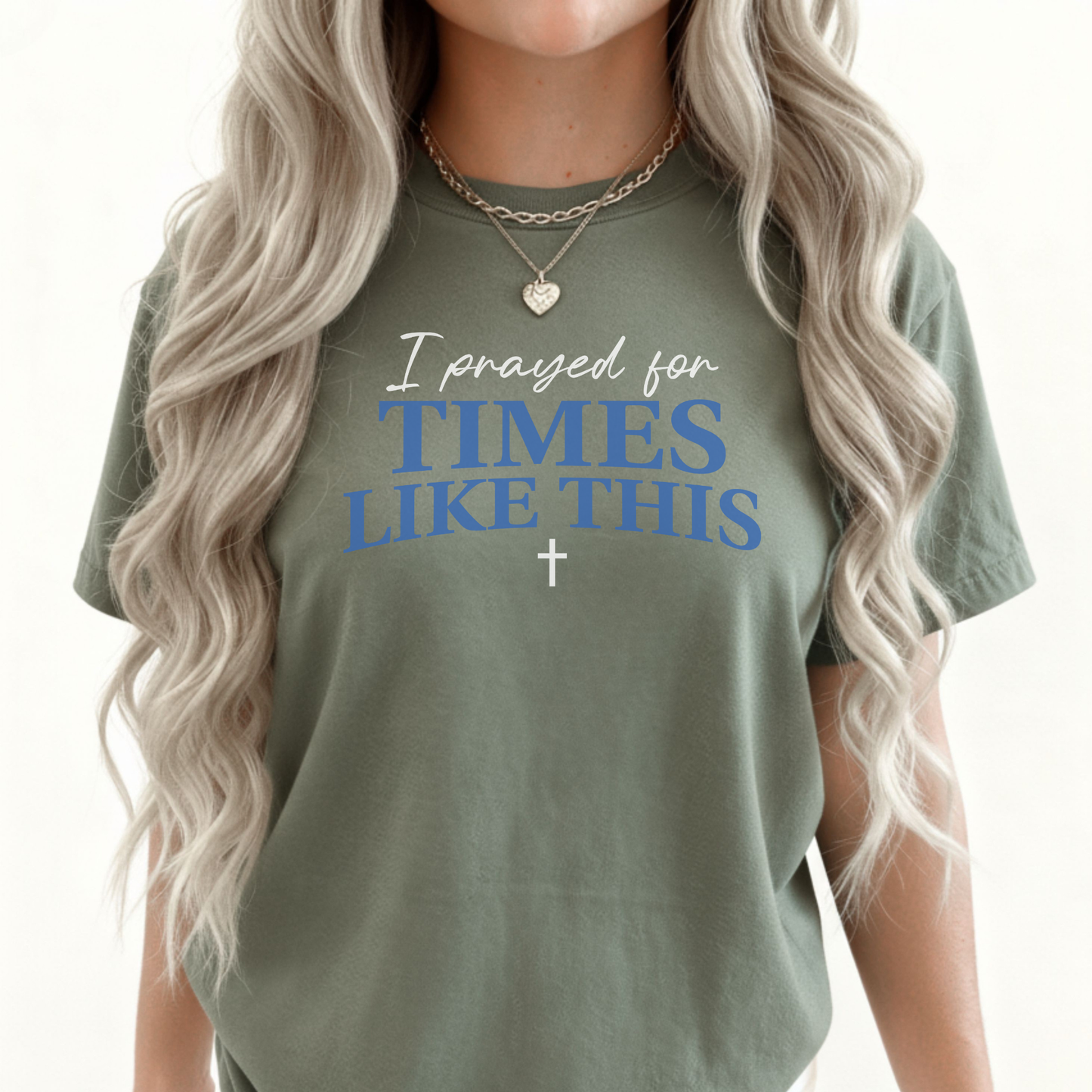 Person wearing a green t-shirt with text 'I prayed for TIMES LIKE THIS' and a cross symbol.