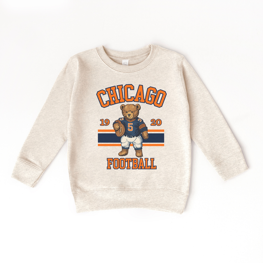 Beige sweatshirt with Chicago football graphic featuring a bear holding a football on a white background
