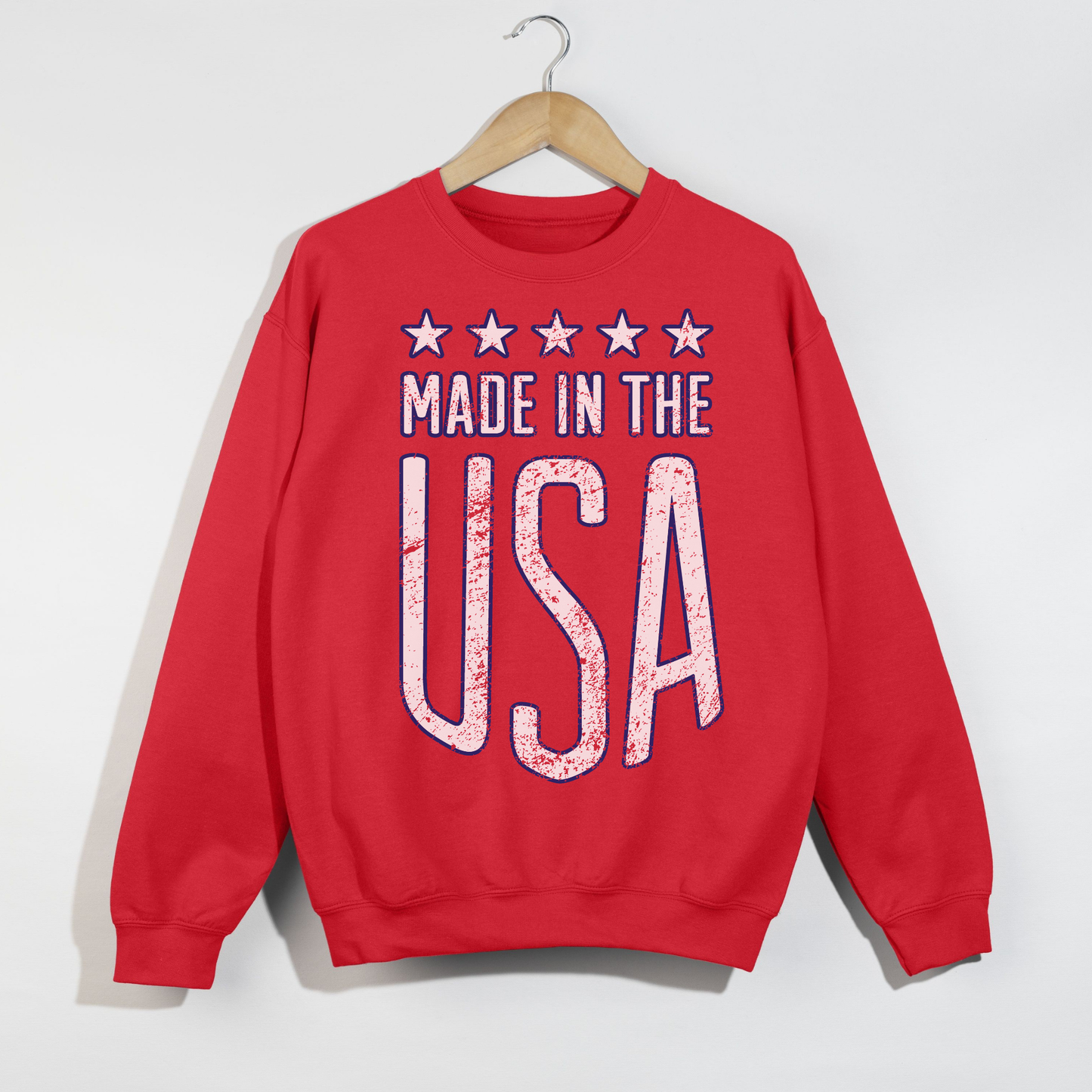 Red Made in the USA graphic crewneck sweatshirt hanging on hanger vintage distressed USA design
