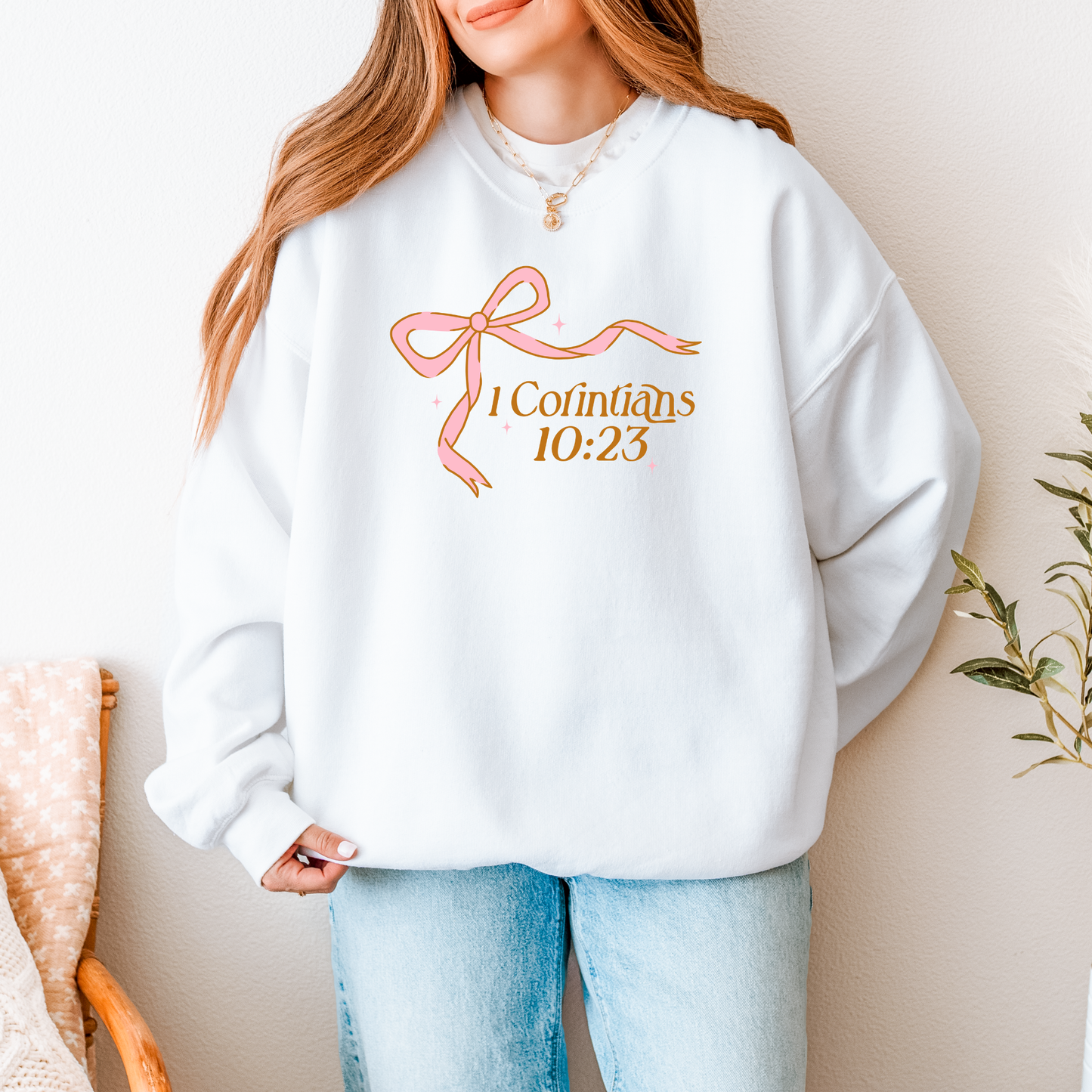 White 1 Corinthians 10:23 Christian sweatshirt with pink bow and gold lettering — American Apparel RF496