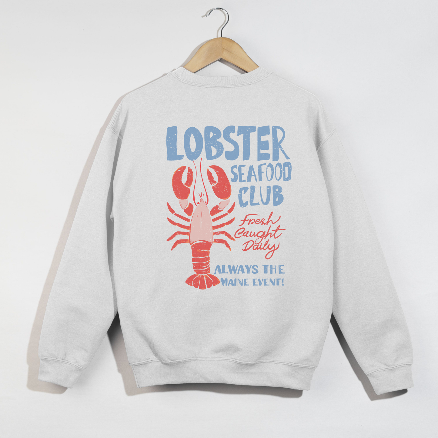 white sweatshirt with lobster graphic and text on a white background