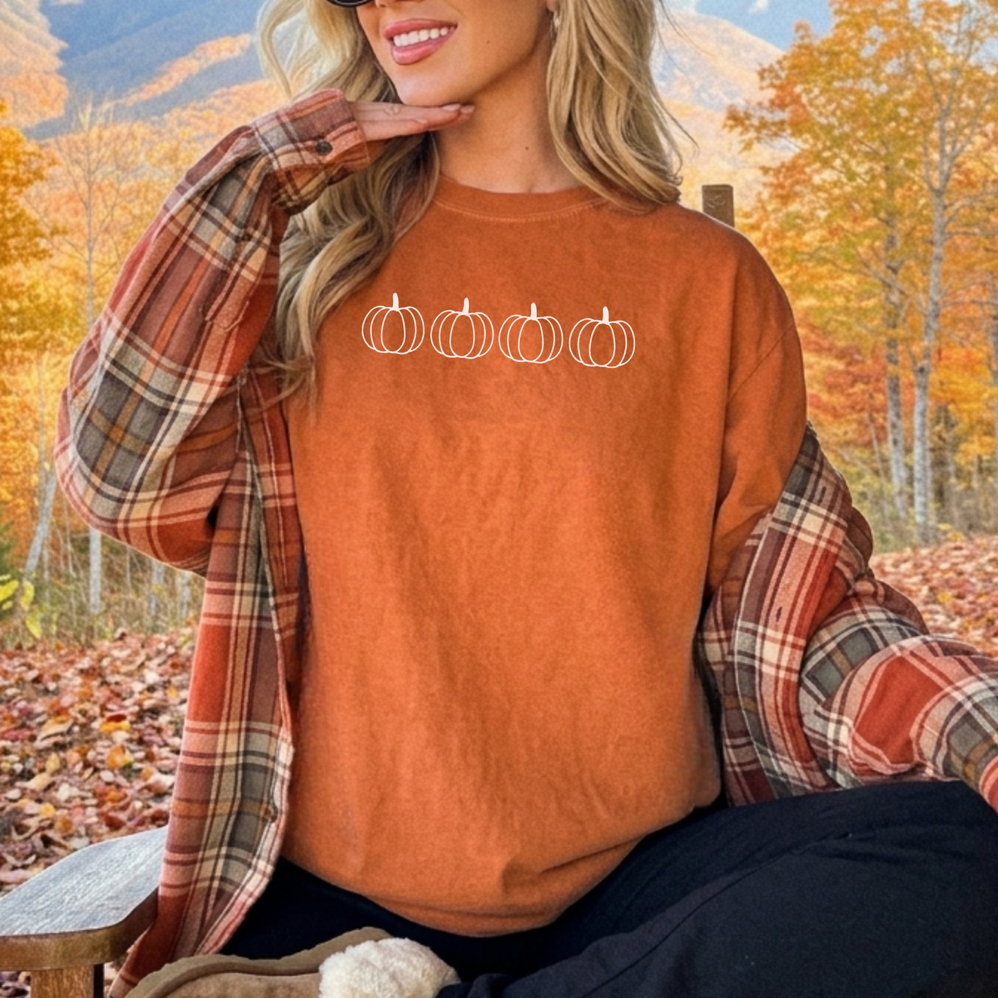 Close-up of a rust orange fall graphic tee featuring four minimalist white outline pumpkins for a timeless autumn outfit.