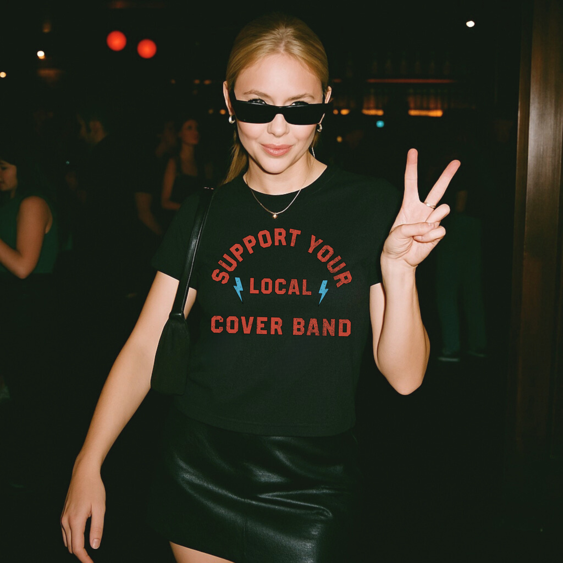Black fitted baby tee with vintage rock graphic styled with leather skirt edgy night out outfit