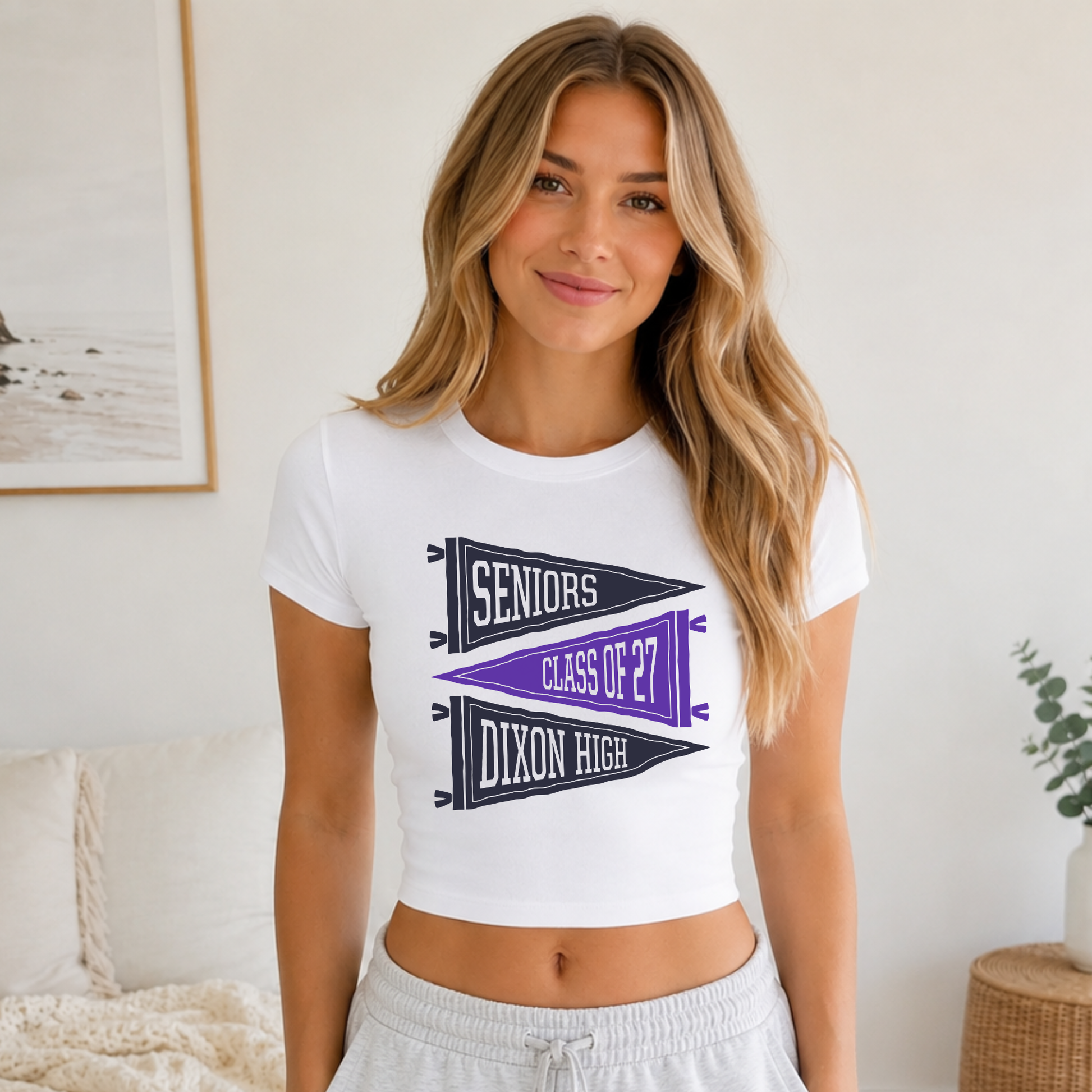 Close-up lifestyle mockup of Dixon High Class of 2027 senior graphic fitted baby tee.