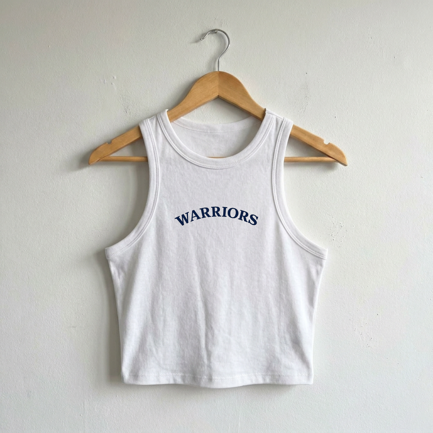White ribbed crop tank featuring navy Sterling Warriors arched varsity graphic