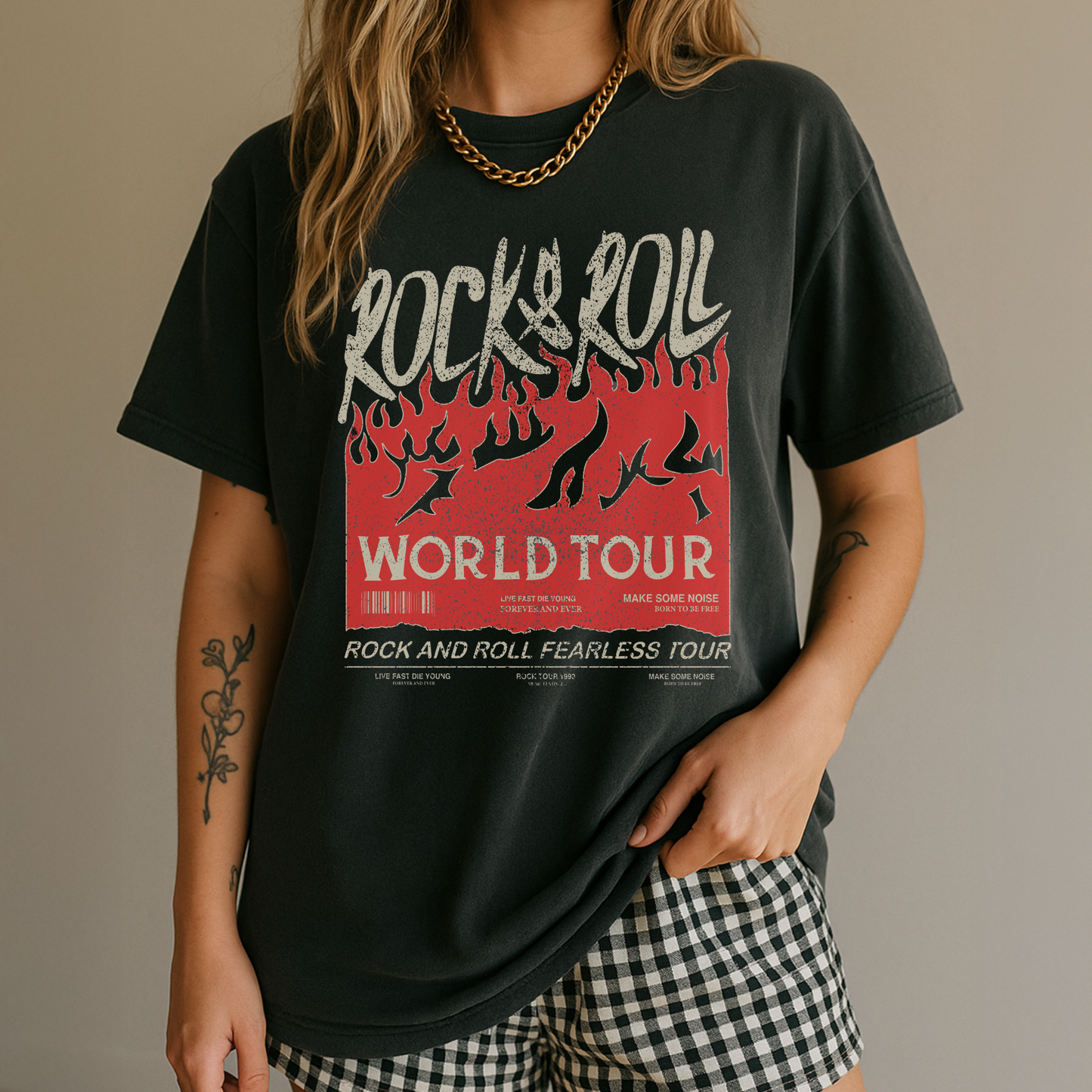 Person wearing a black t-shirt with 'Rock & Roll World Tour' design on a plain background