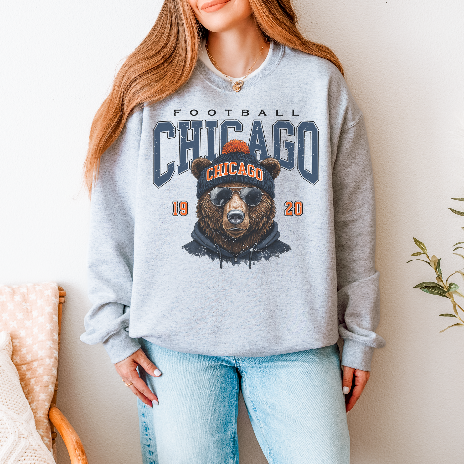 Person wearing a gray sweatshirt with a bear graphic and 'Chicago' text.