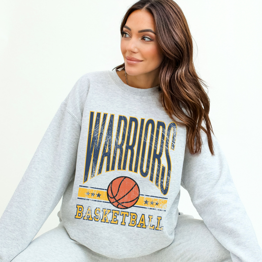 Woman wearing a gray sweatshirt with 'Warriors Basketball' print on a white background
