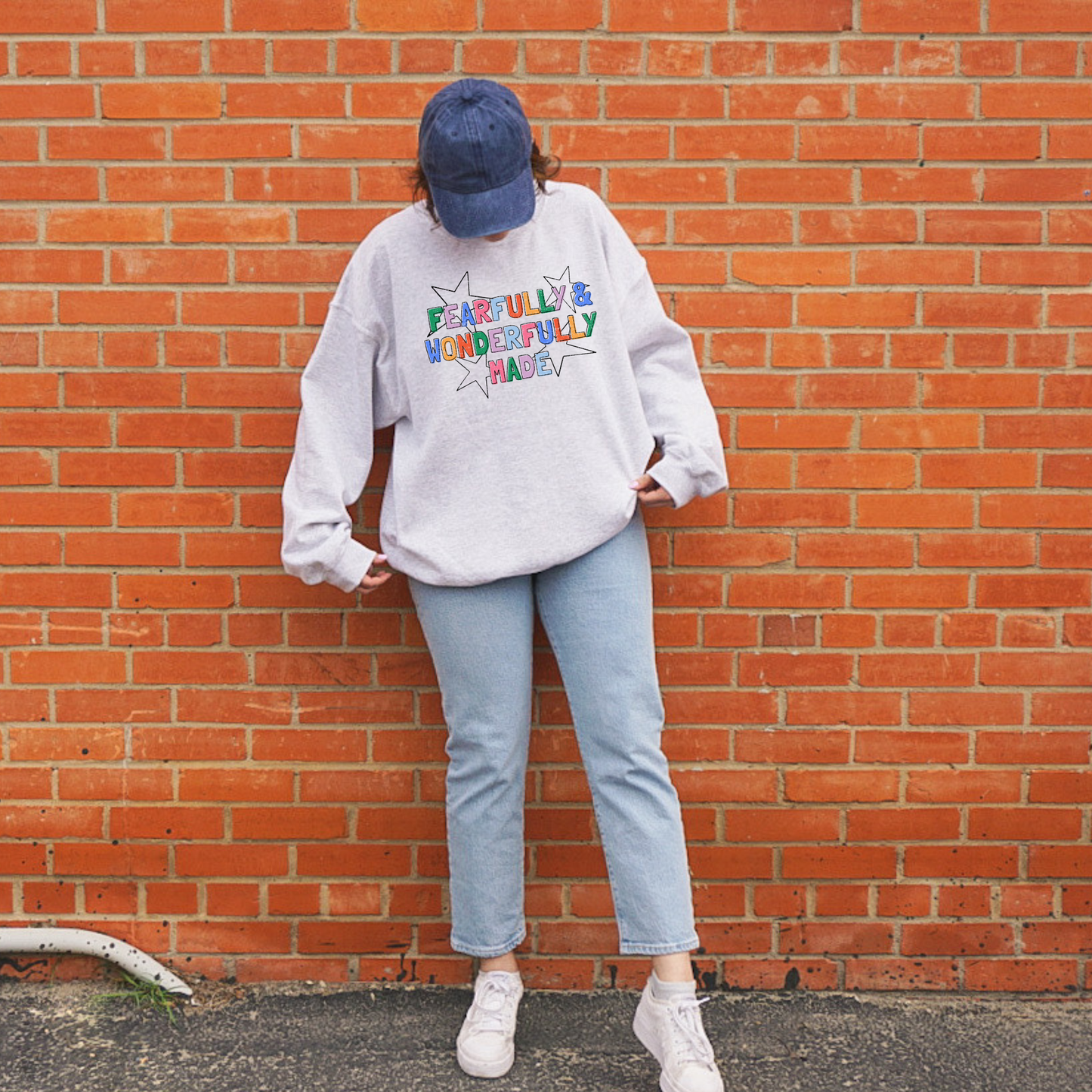woman wearing oversized christian sweatshirt fearfully and wonderfully made colorful graphic casual outfit
