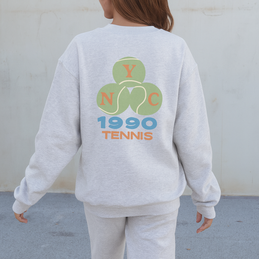 Ash grey tennis crewneck sweatshirt showing full back graphic outdoors