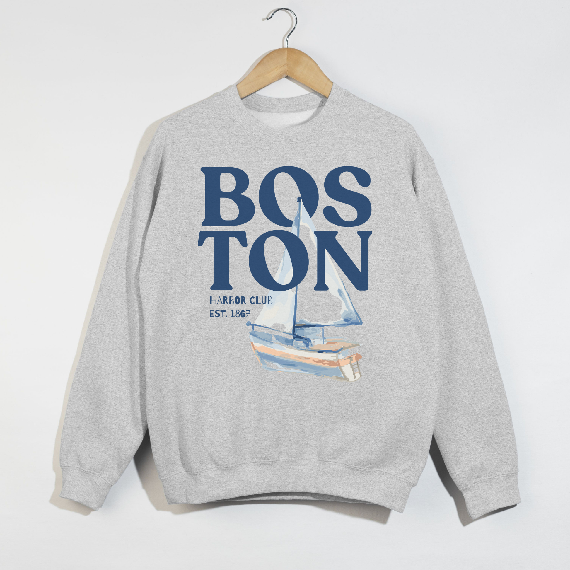 Ash grey Boston Harbor Club sweatshirt with vintage blue sailboat graphic and nautical Boston typography flat lay mockup