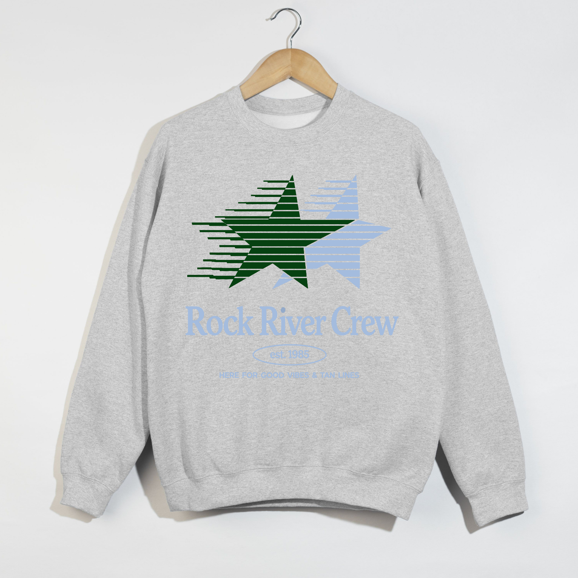 Gray sweatshirt with a star design and 'Rock River Crew' text on a white background