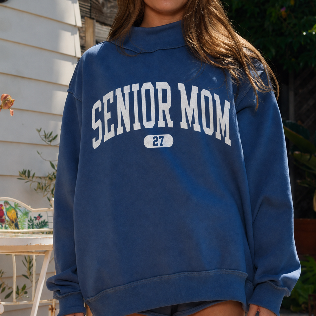 Navy reversible Senior Mom sweatshirt worn inside out featuring oversized white SENIOR MOM graphic with 27 underneath.