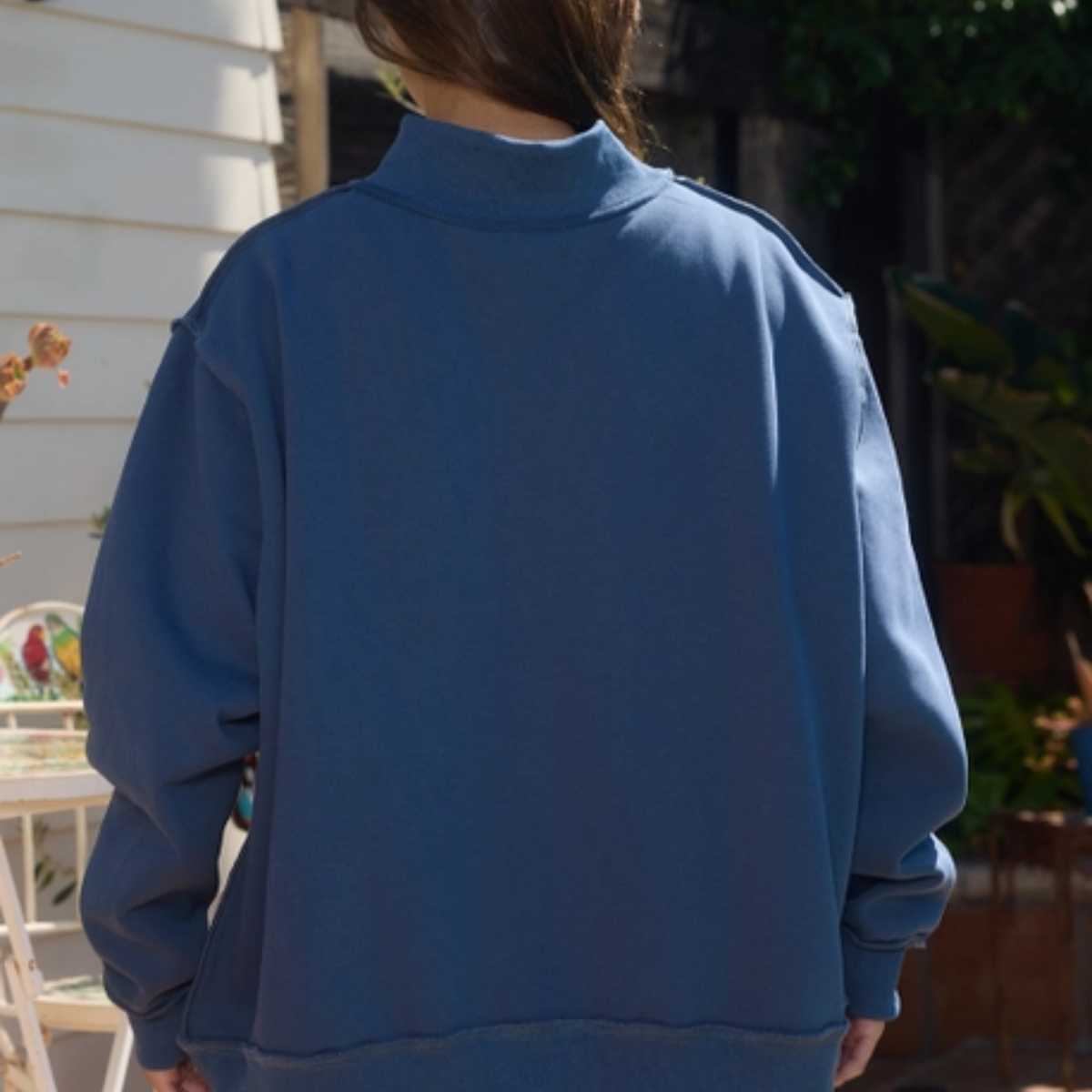 Back view of navy Senior Mom reversible mock neck sweatshirt worn inside out showing the alternate reversible construction.