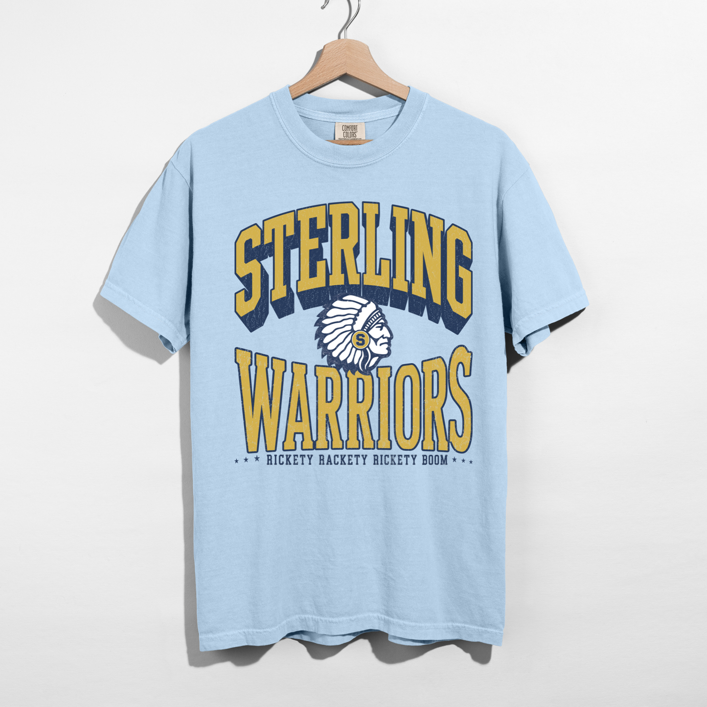 Chambray blue Sterling Warriors Football graphic tee with distressed varsity lettering, football artwork, and classic navy and gold school spirit design.