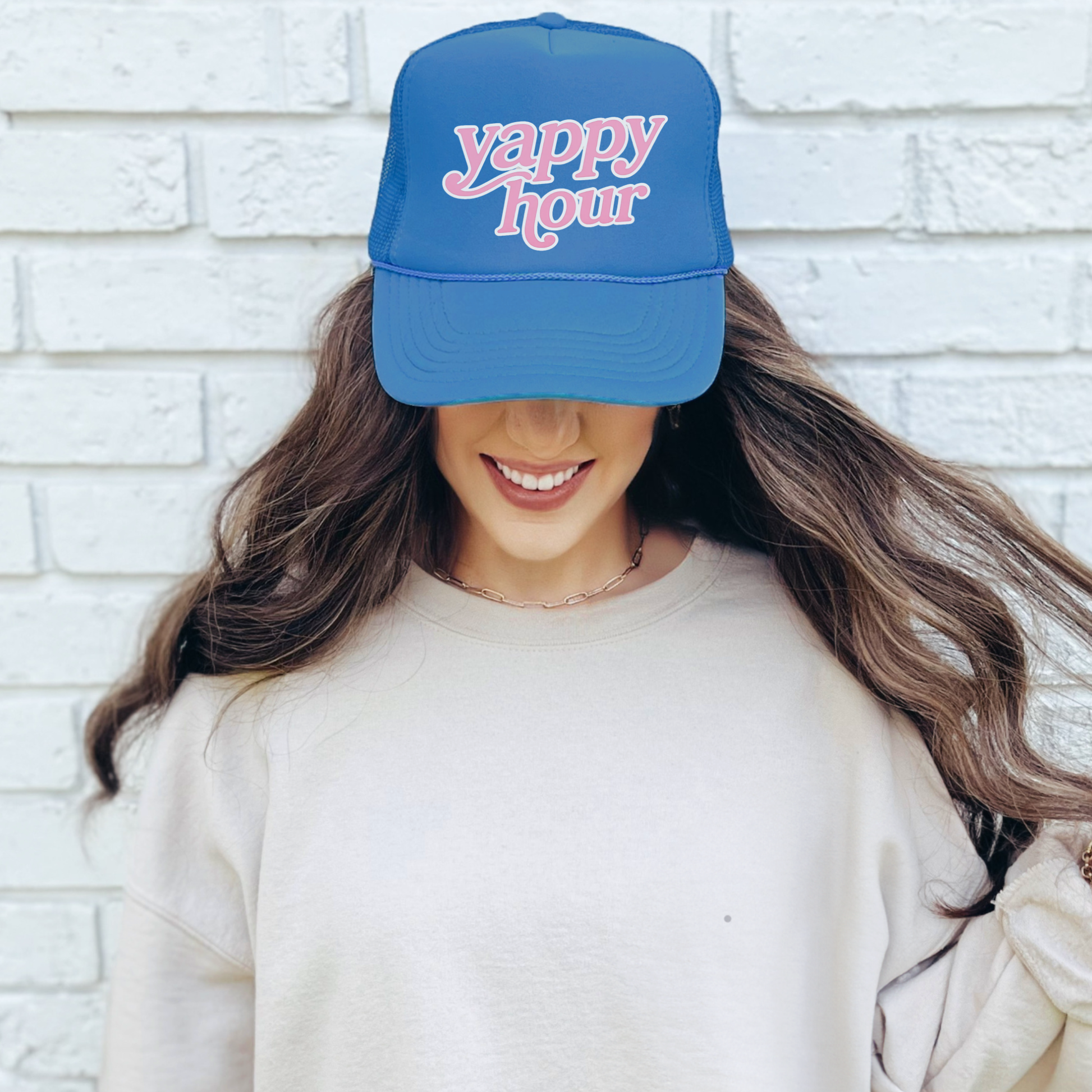 Woman wearing blue yappy hour foam trucker hat