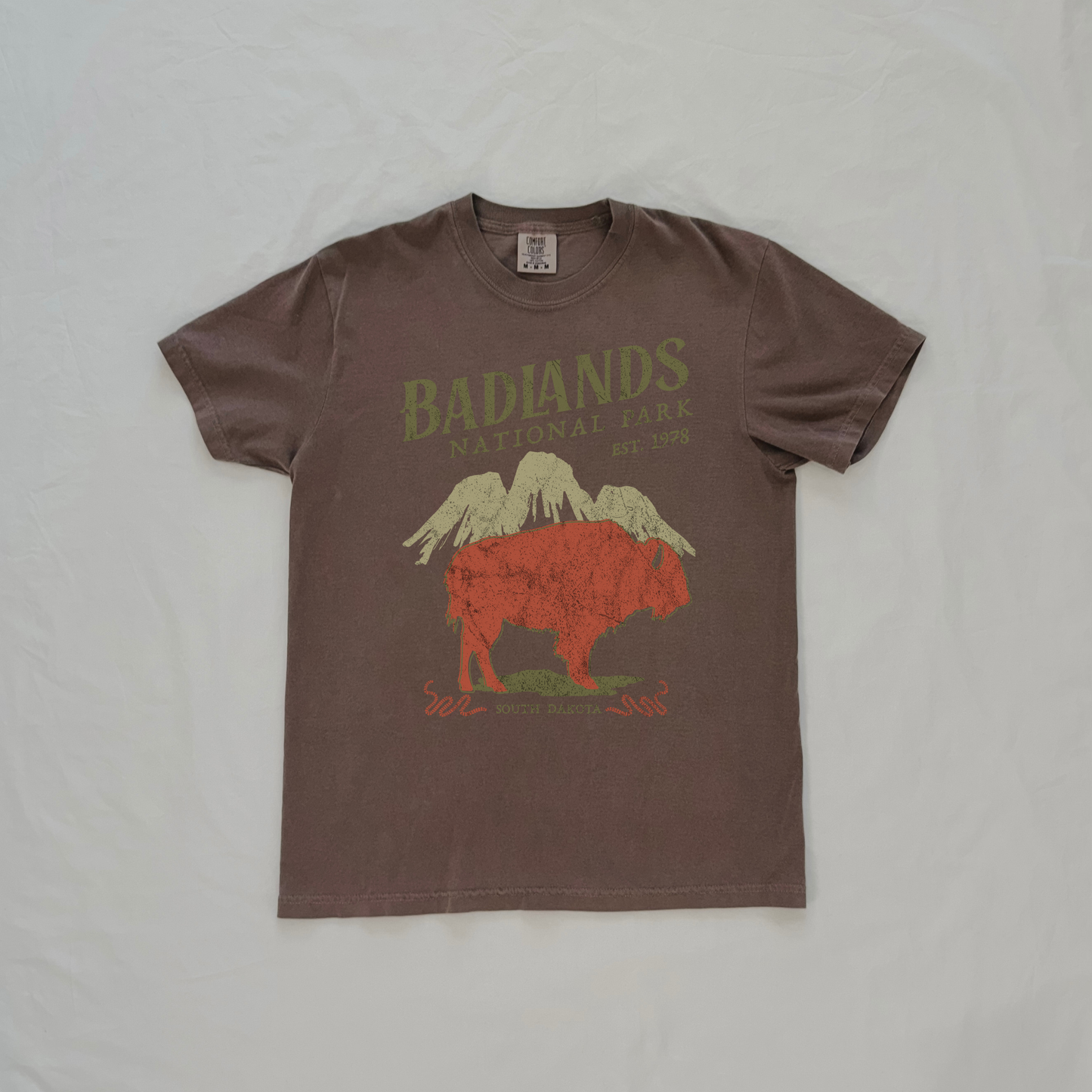 Close-up of vintage Badlands National Park bison graphic showing distressed artwork on espresso t shirt