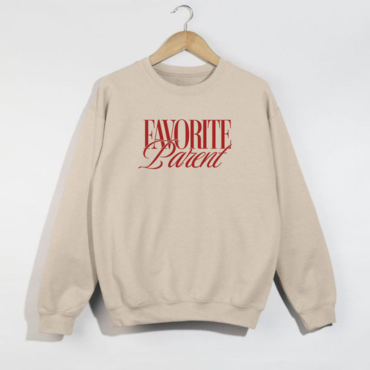 Sand Favorite Parent sweatshirt with red lettering hanging on wooden hanger against white background