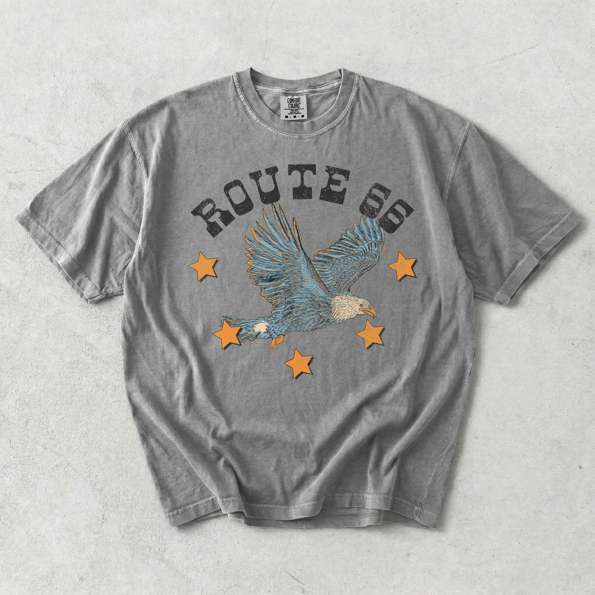 Grey Comfort Colors Route 66 eagle graphic tee flat lay with vintage distressed Americana design