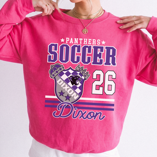 Woman wearing a bright pink Dixon Panthers Soccer 2026 sweatshirt with purple varsity lettering and Panthers crest graphic.