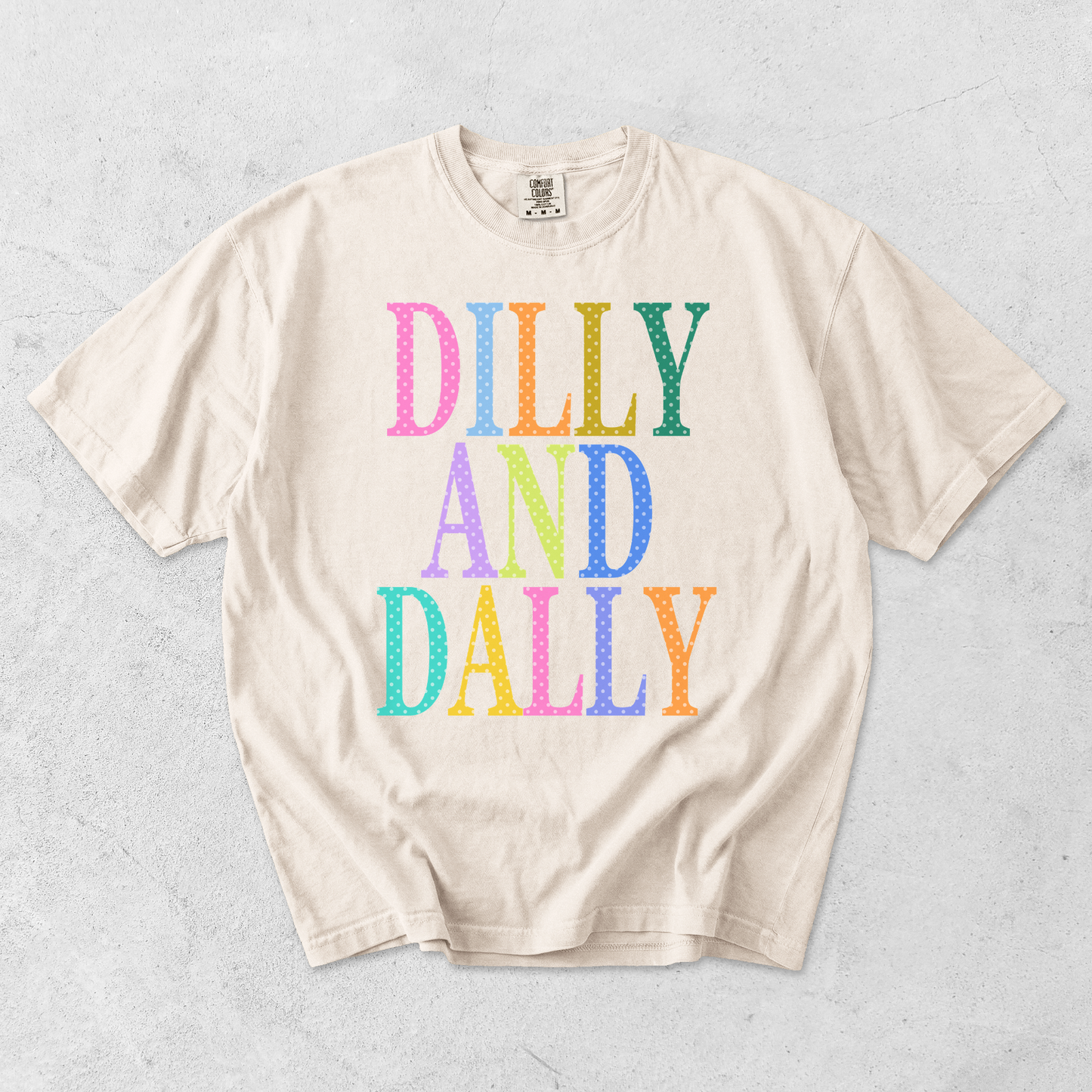 Ivory Comfort Colors graphic tee with colorful Dilly and Dally retro polka dot design flat lay mockup