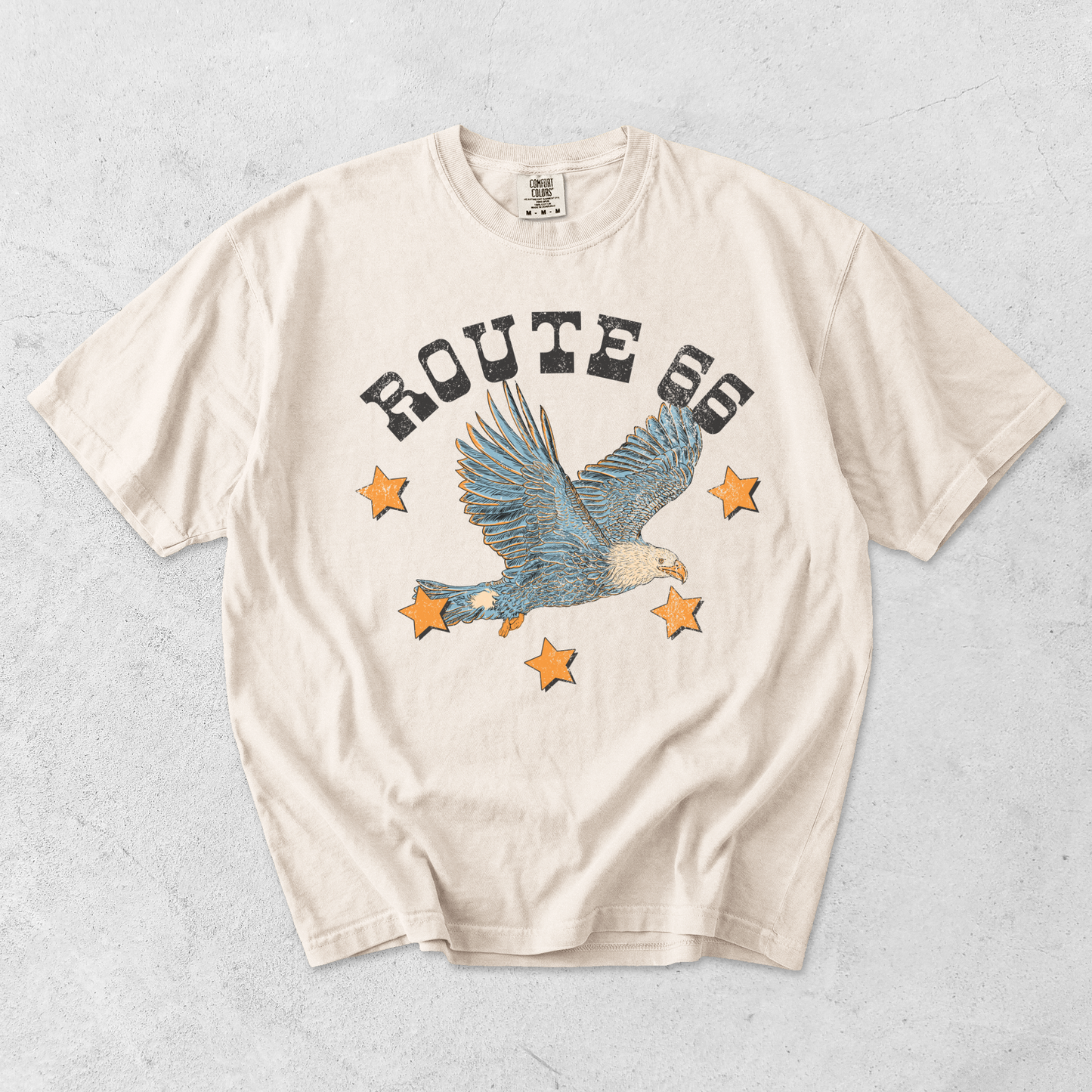 Ivory Comfort Colors Route 66 eagle graphic tee flat lay with vintage Americana eagle and star design