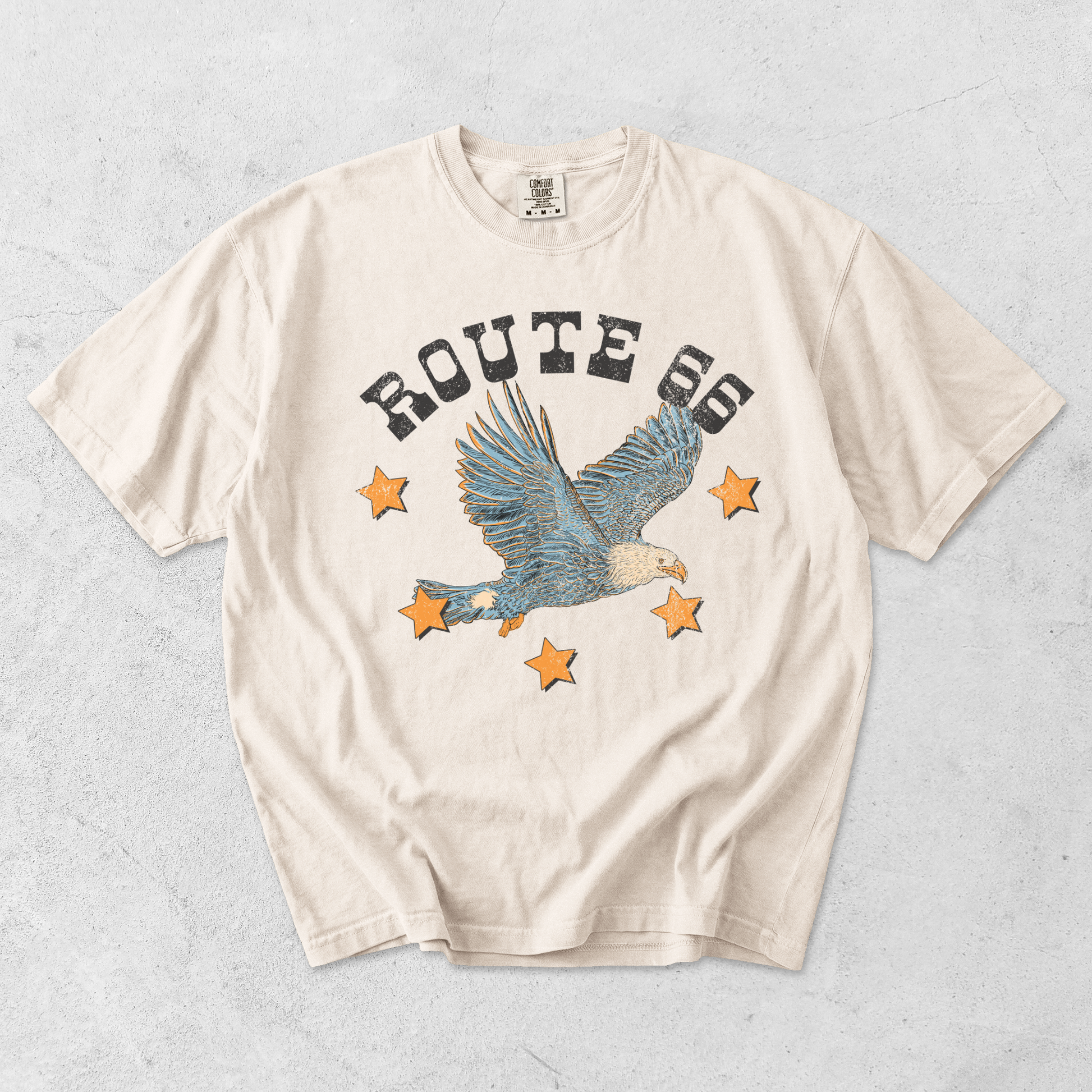 Ivory Comfort Colors Route 66 eagle graphic tee flat lay with vintage Americana eagle and star design
