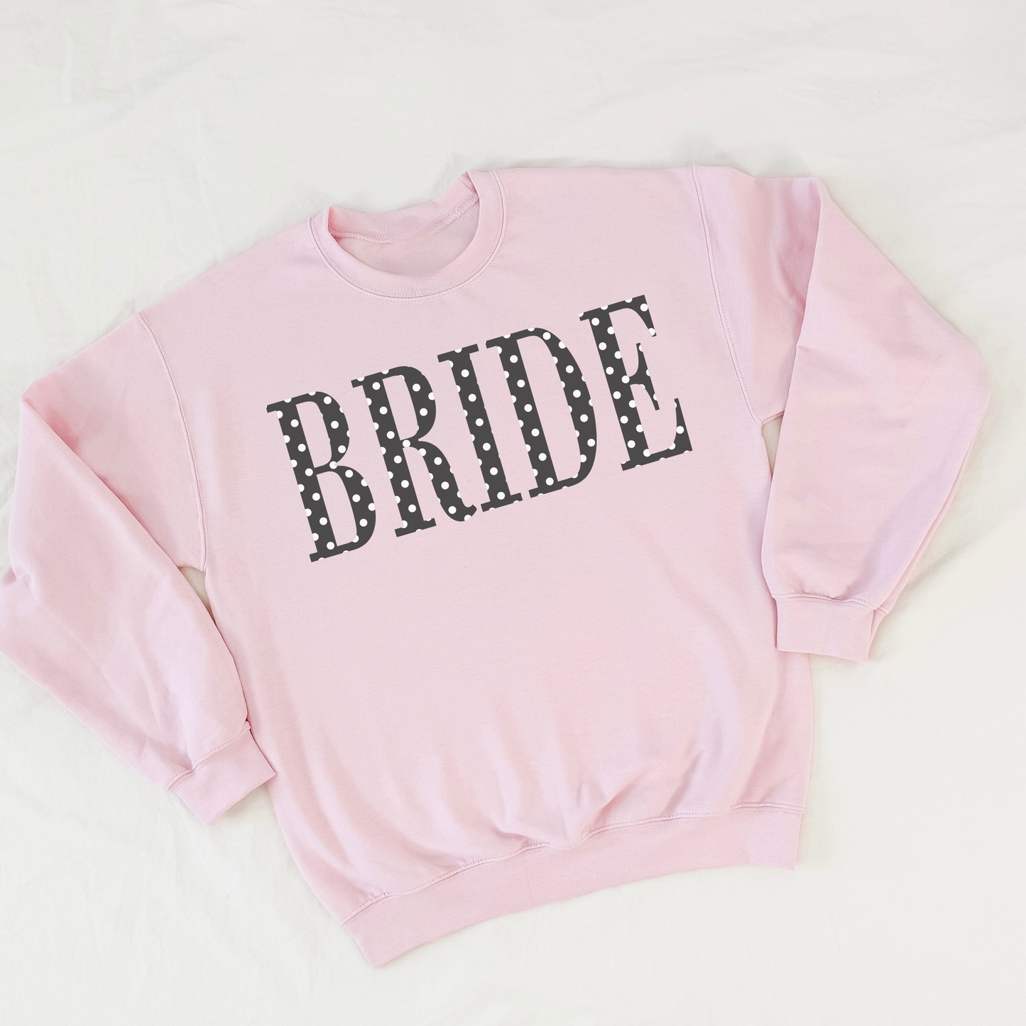 Pink BRIDE polka dot crewneck sweatshirt flat lay on white background