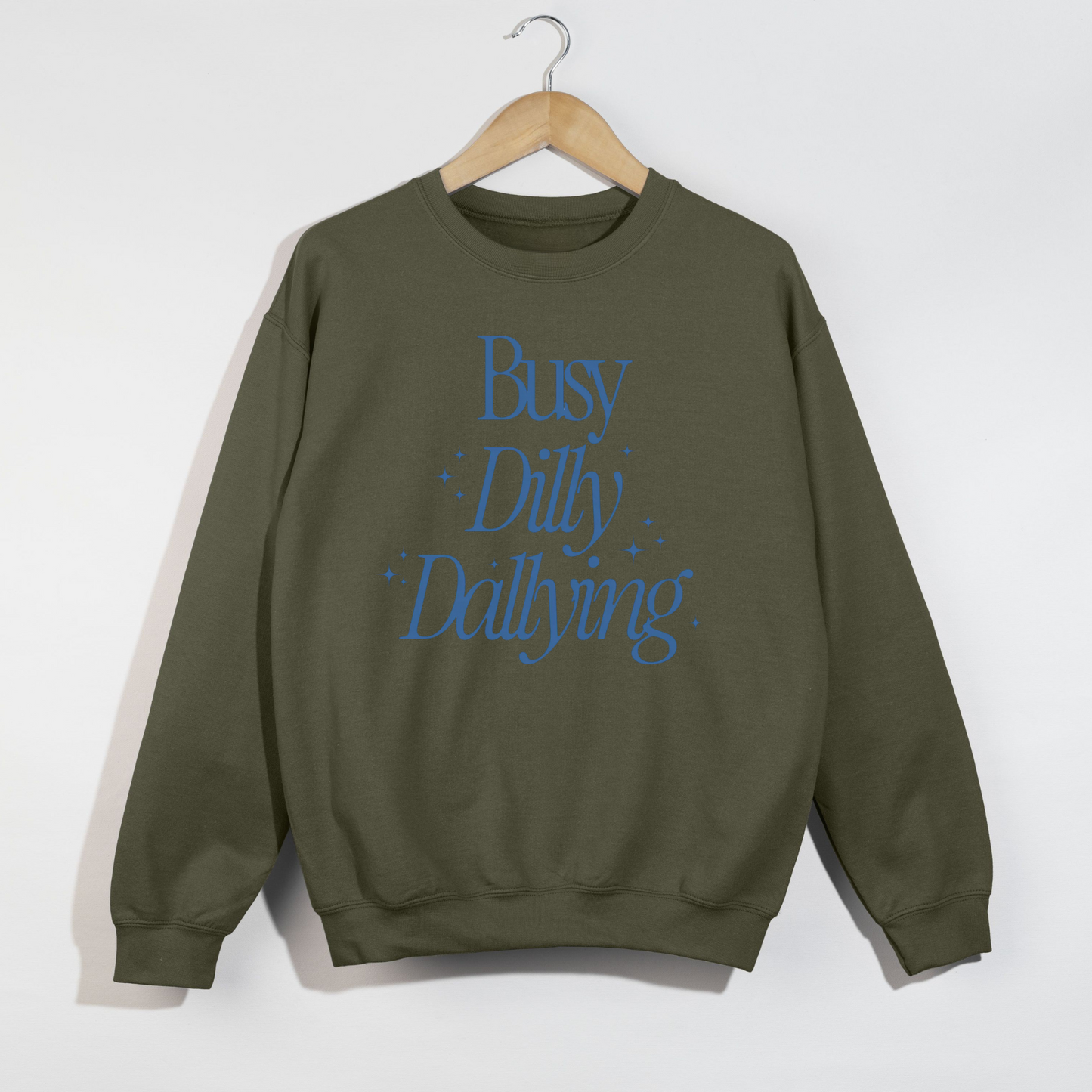 Green sweatshirt with blue text 'Busy Dilly Dallying' on a white background
