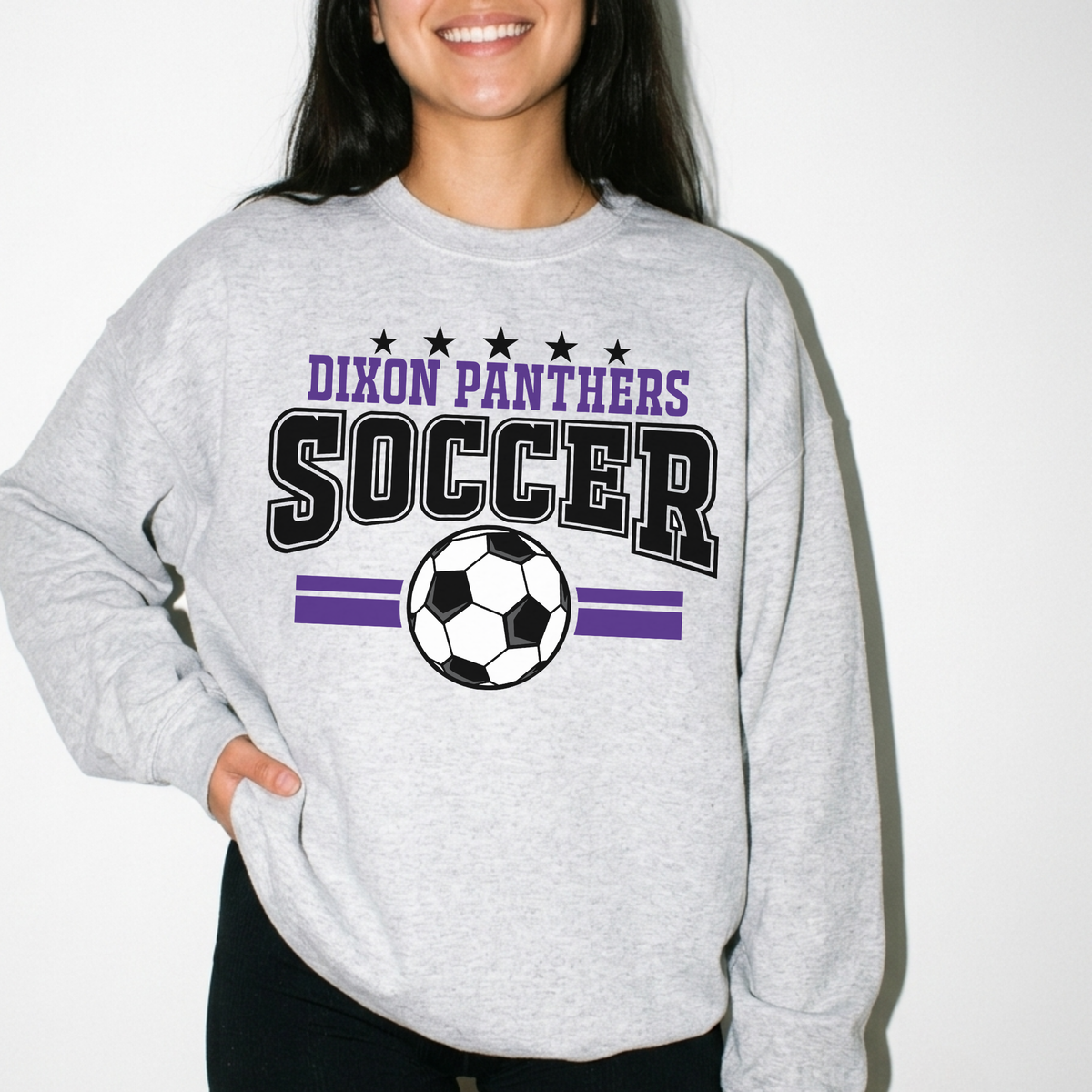Woman wearing heather grey Dixon Panthers varsity soccer sweatshirt with purple and black graphic