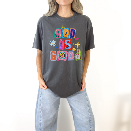 Woman wearing dark gray God Is Good colorful graphic tee styled casually