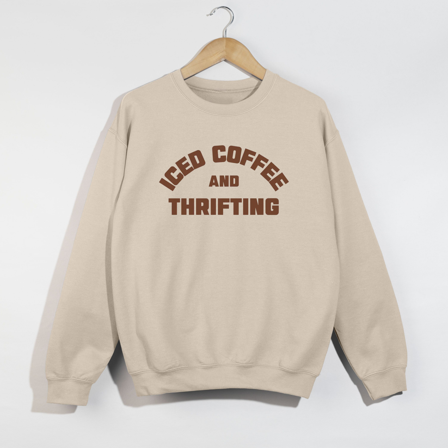 Sand colored iced coffee and thrifting crewneck sweatshirt with cozy neutral aesthetic