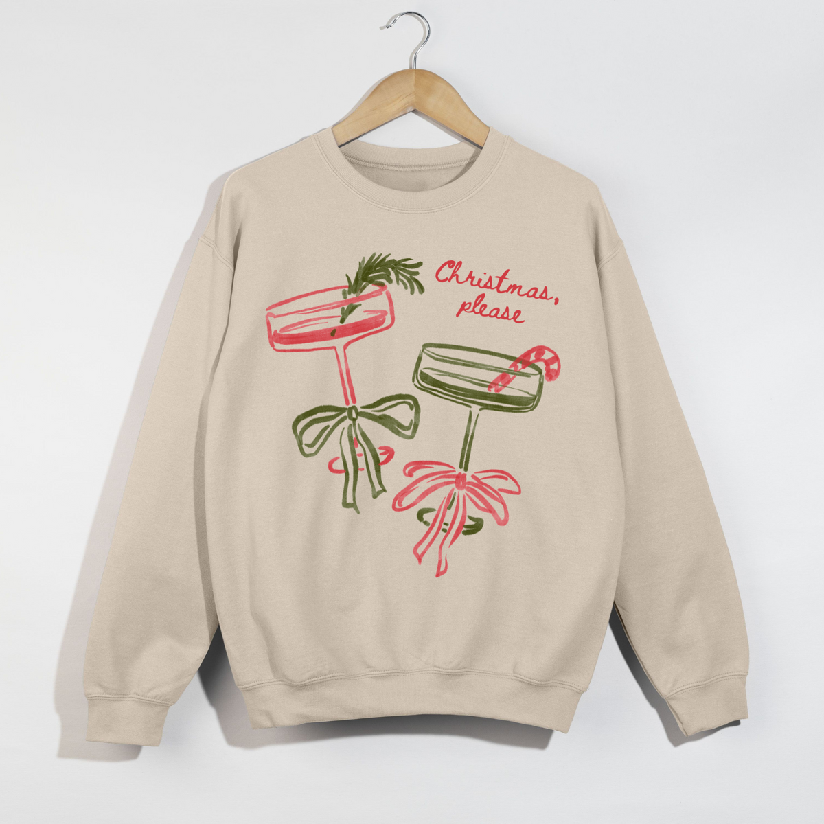 Beige sweatshirt with Christmas-themed designs and text on a white background