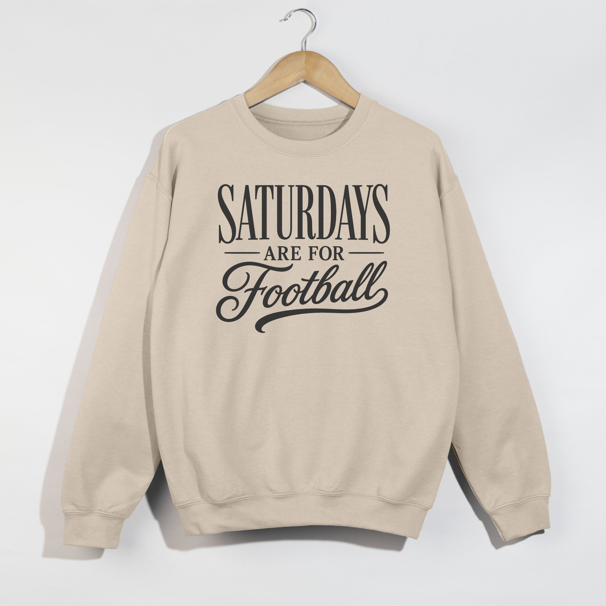 Sand graphic sweatshirt featuring the phrase "Saturdays Are For Football" in vintage black typography on a cozy unisex crewneck.