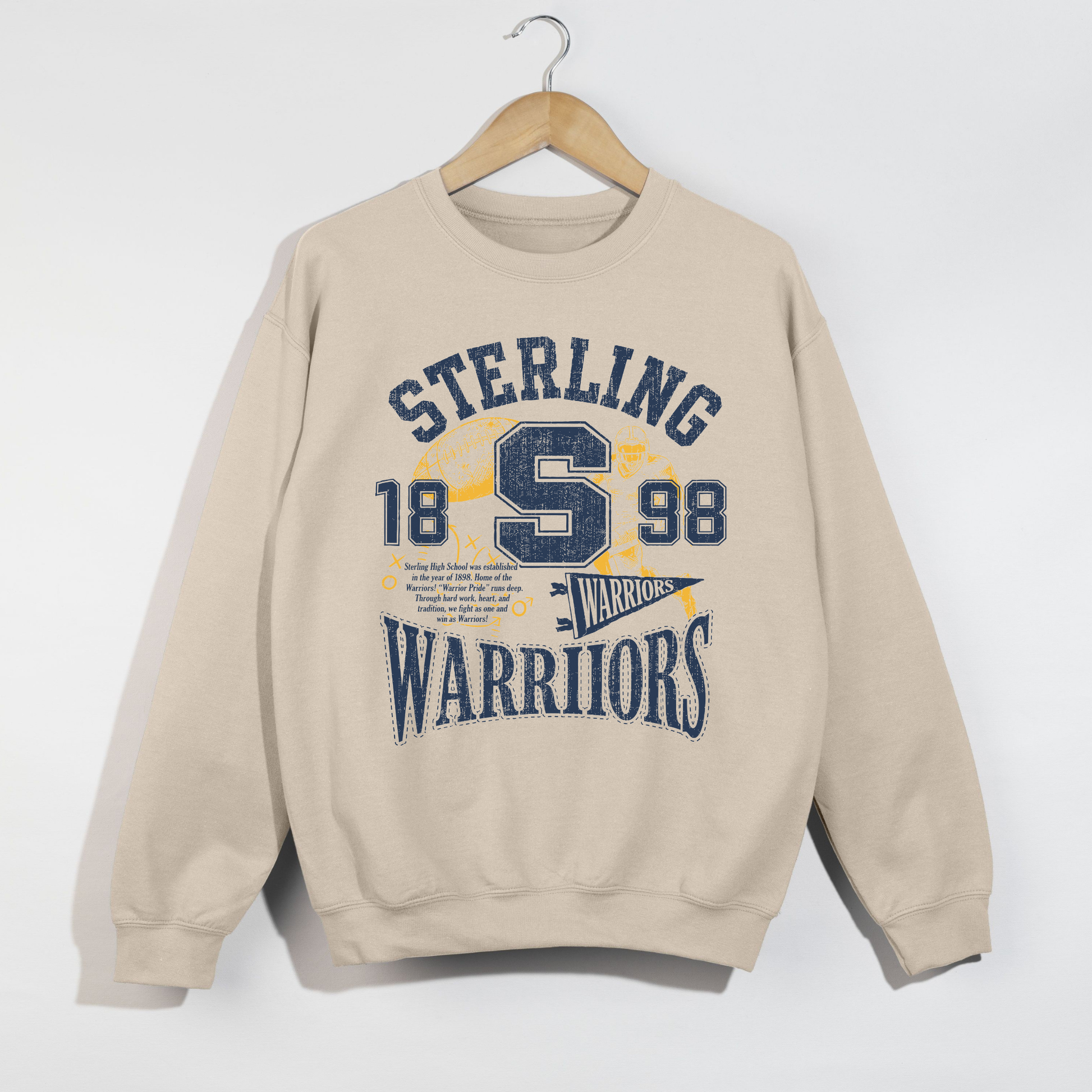 Sand Sterling Warriors football graphic sweatshirt with vintage collegiate artwork in navy and gold.