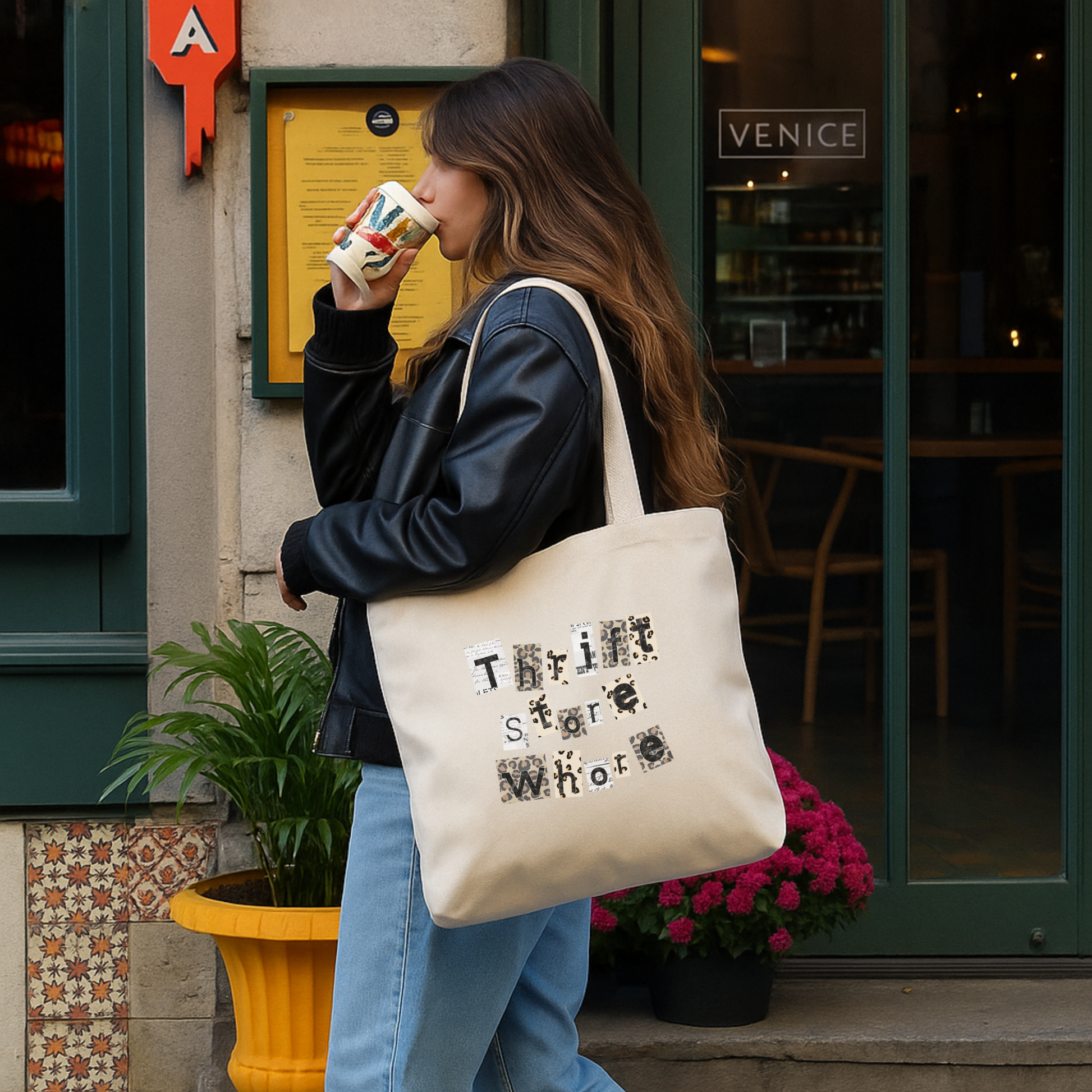 Woman carrying canvas tote bag with Thrift Store Whore graphic text while walking outdoors