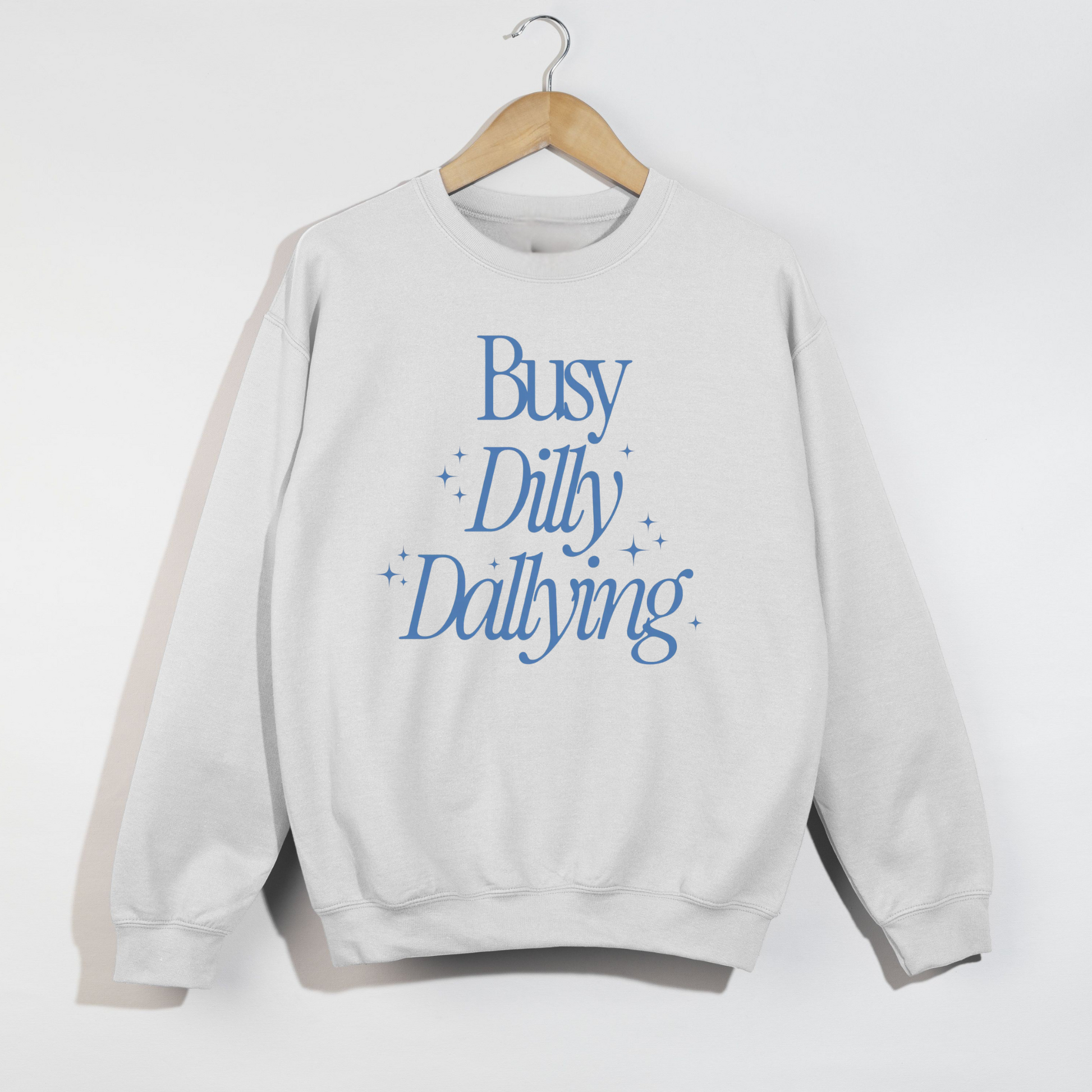 White sweatshirt with blue text 'Busy Dilly Dallying' on a white background