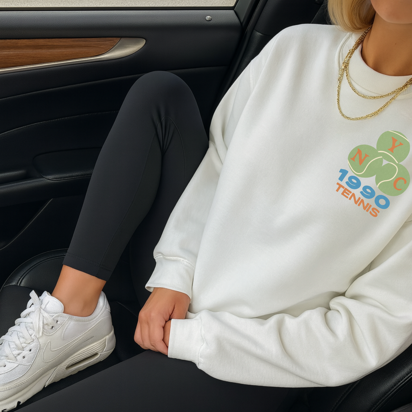 White NYC 1990 tennis sweatshirt styled with leggings inside car