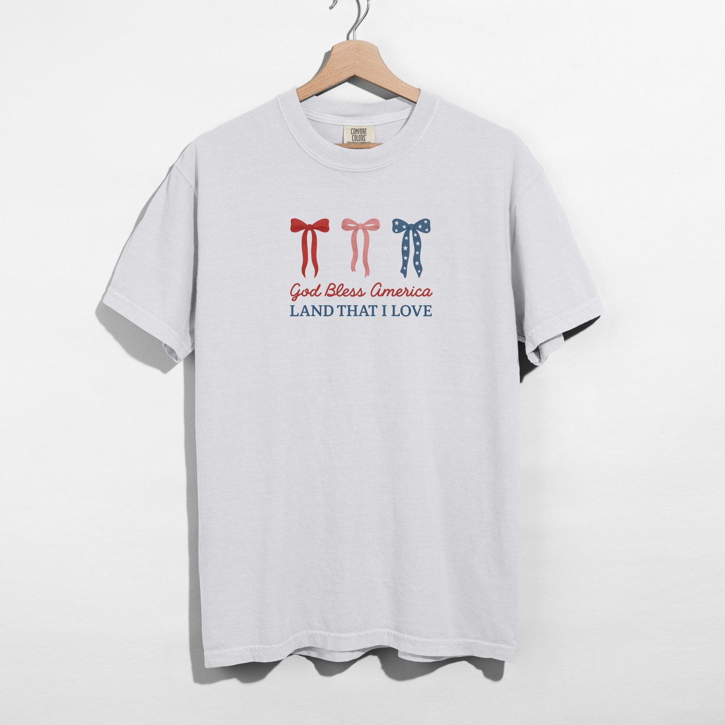 White t-shirt with graphic design on a hanger against a white background
