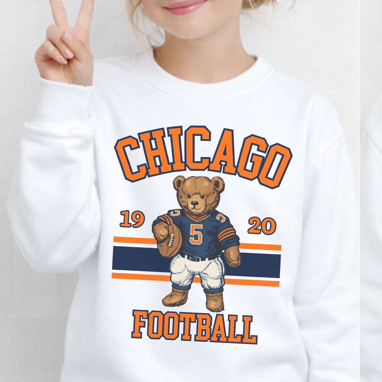 White sweatshirt with Chicago Football design featuring a bear holding a football.