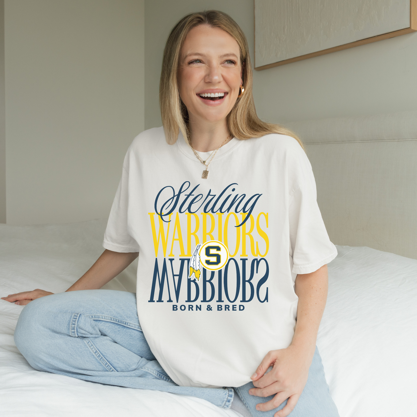 Woman wearing white Sterling Warriors Born and Bred unisex school spirit t shirt