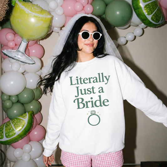 Bride wearing Literally Just a Bride sweatshirt at bachelorette party with veil