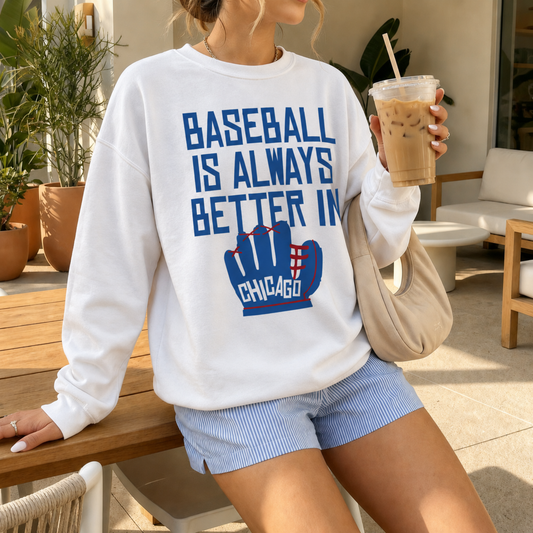 Woman wearing oversized white Baseball Is Always Better In Chicago sweatshirt with blue and red baseball glove graphic holding iced coffee