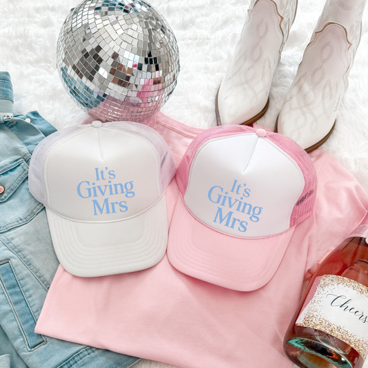 Matching white and pink It’s Giving Mrs trucker hats styled with disco ball and boots