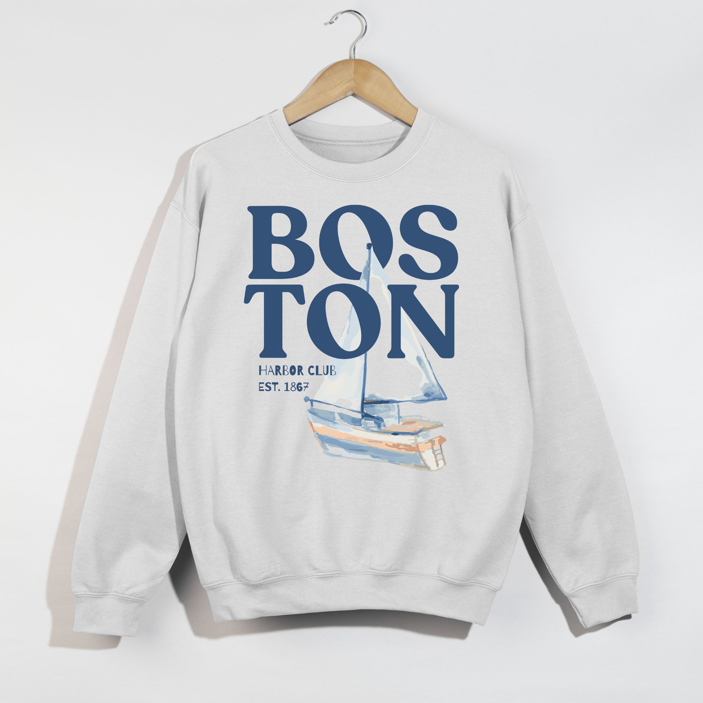 White Boston Harbor Club sweatshirt with vintage sailboat graphic and blue coastal typography flat lay mockup