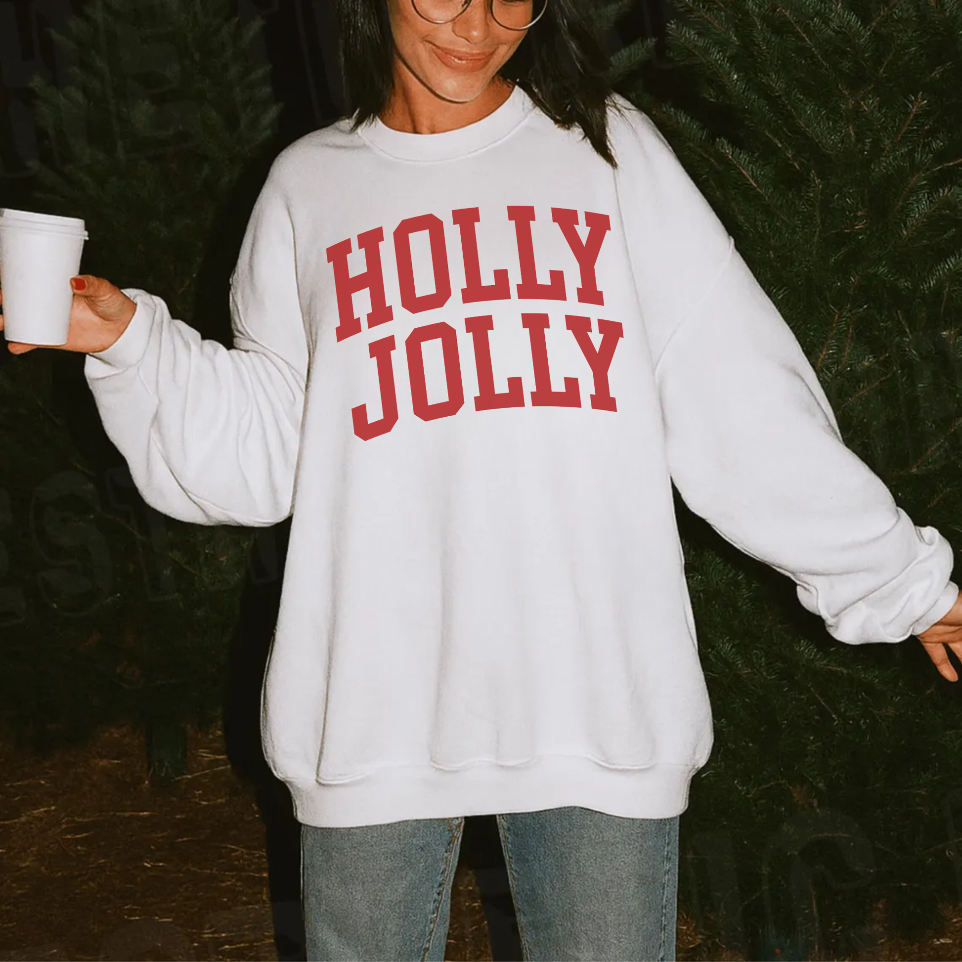 Close-up of a white Holly Jolly Christmas sweatshirt featuring bold red collegiate-style lettering.