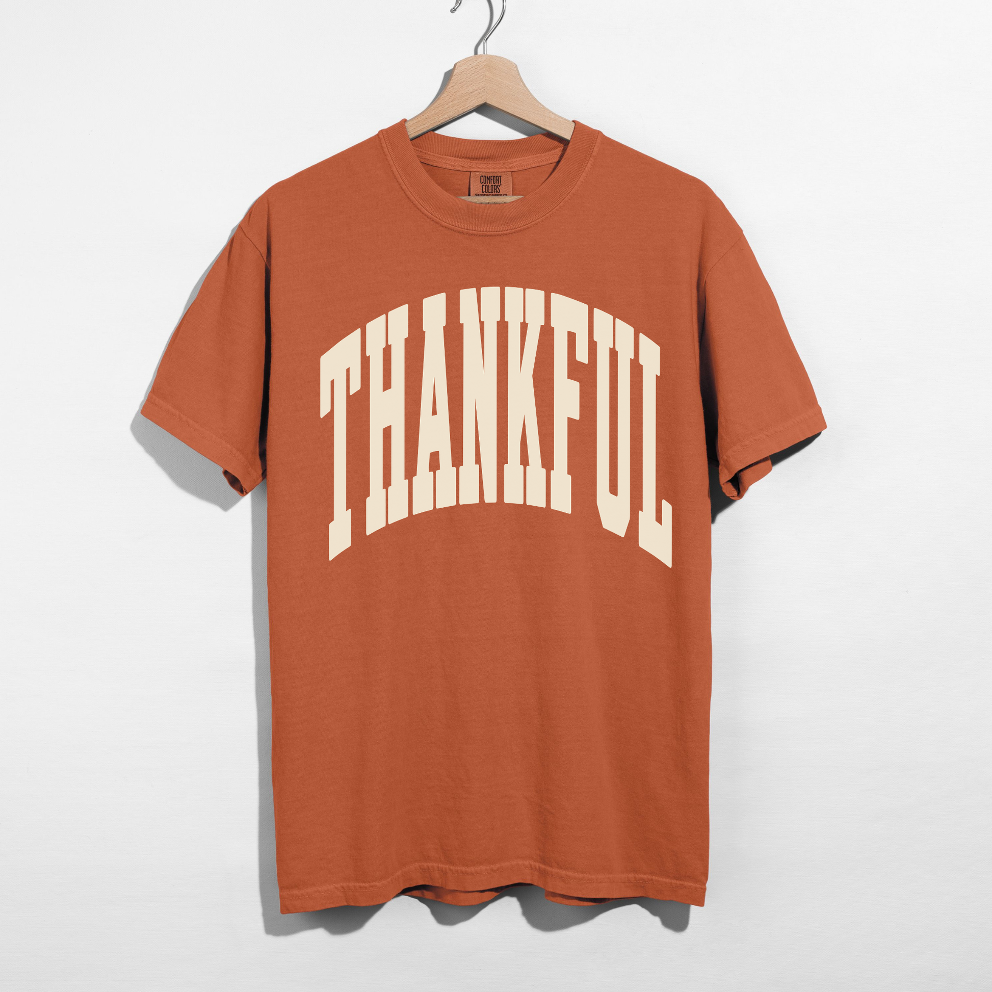 Yam orange Thankful graphic tee with oversized cream collegiate lettering for a fall Thanksgiving outfit
